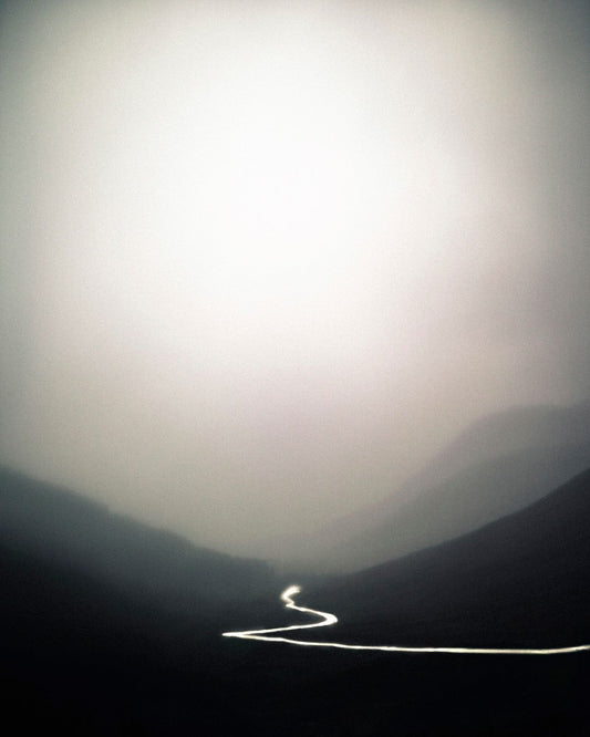 A photograph featuring a landscape with a river running through it, printed on a Giclée Hahnemühle photo rag with a white border.