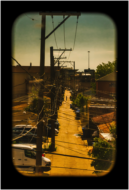 A street scene with power lines and buildings in the background.