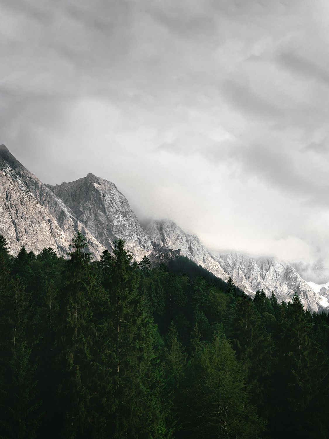 A landscape photo featuring mountains with clouds in the background, intended for mounting and framing.