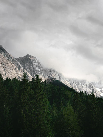 A landscape photo featuring mountains with clouds in the background, intended for mounting and framing.