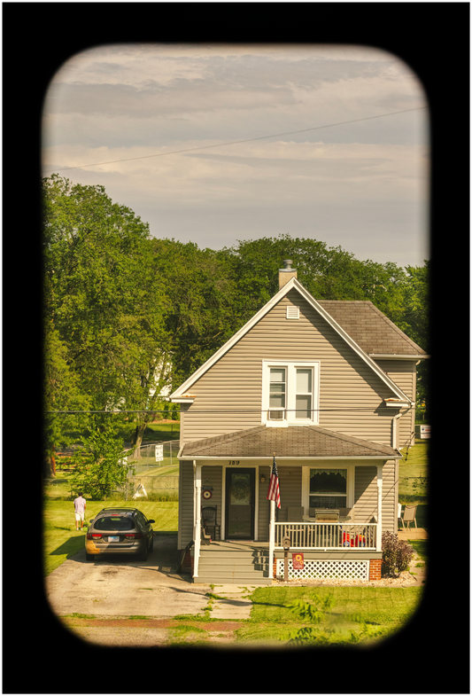 A printed image featuring a house with a tree in the foreground, part of a series 'Portrait of America'.