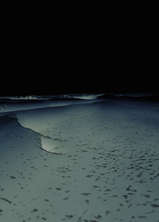 An image of a beach at night with visible waves and shadows.