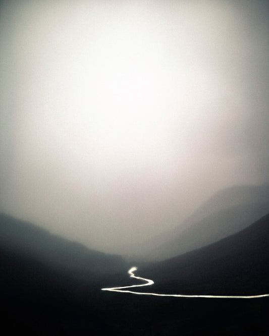 A photograph featuring a landscape with a river running through it, printed on a Giclée Hahnemühle photo rag with a white border.