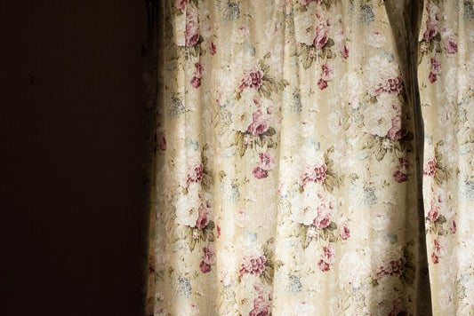A floral printed artwork featuring a bedroom window, with a white border for mounting.