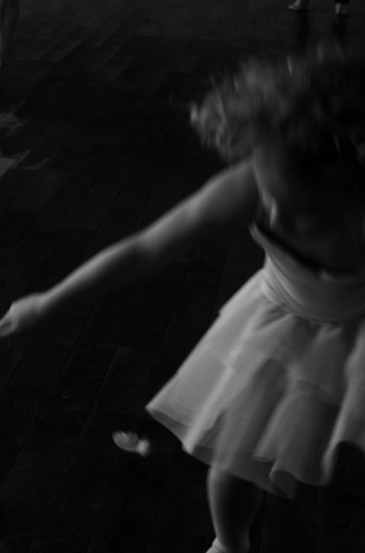 A black and white image of a person dancing, edged with a dark outline that suggests a silhouette.