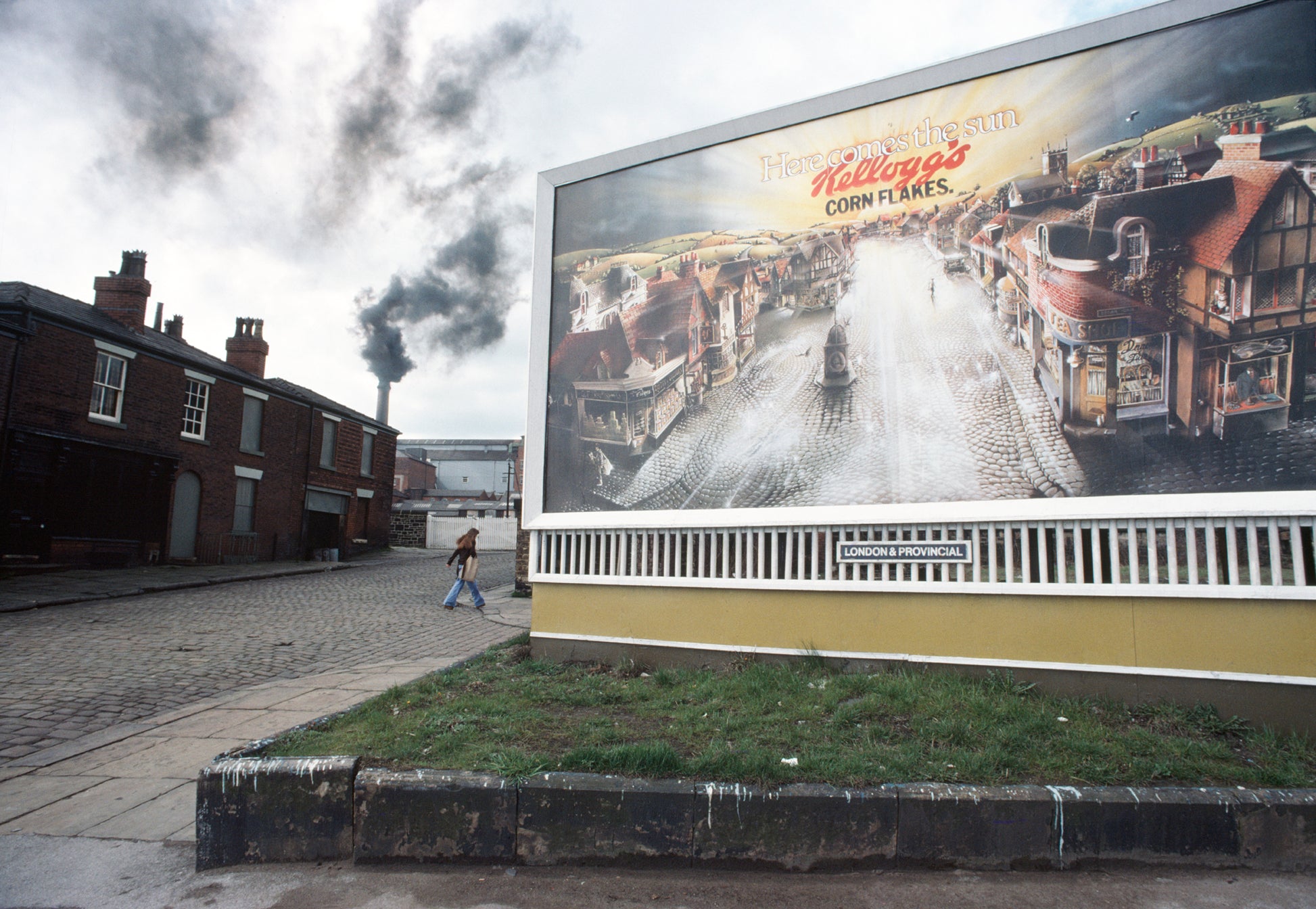 A photograph featuring a billboard with an image of a city street and buildings, with the text 'Kellogg's CornFLAKES' on the billboard.