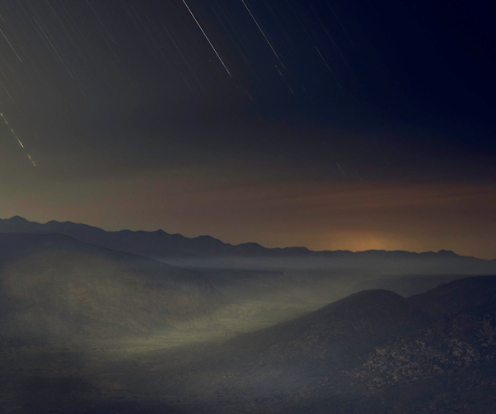 A photographic art print featuring a nightscape with stars and a mountain range.