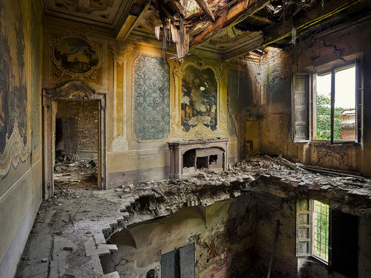 An image of a dilapidated room with a window, fireplace, and decorative wall patterns, indicating a historical or ruined building.